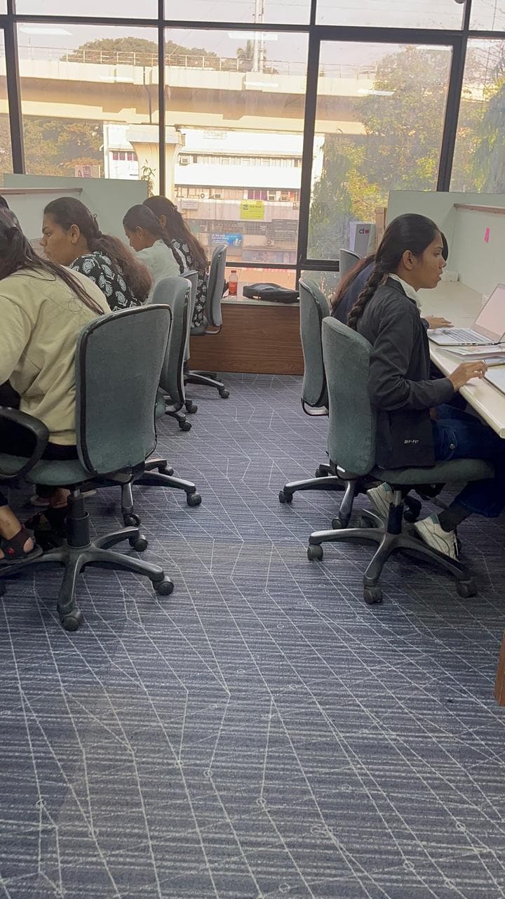 Live teaching session with board and projector screen visible